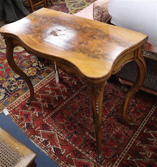 A 19th century French walnut serpentine folding tea table W.88cm